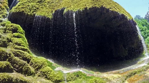 Waterfall dripping from mossy rocks Stock Footage 52063954