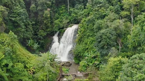 Waterfall Drone Pulling Back Revealing Rainforest Jungle 4K - Thailand Stock Footage 150159388