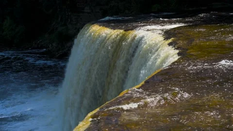 Waterfall drop-off at curved cliff edge Stock Footage 166117013