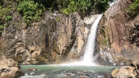 This waterfall drops into a hidden limestone basin Stock Footage 340267986