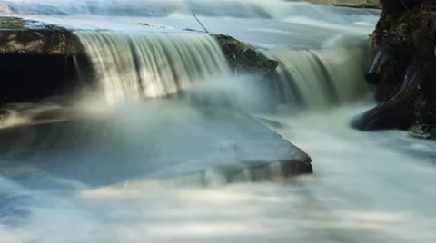 Waterfall in the dynamics on the hillside. Timelapse Stock Footage 67628376