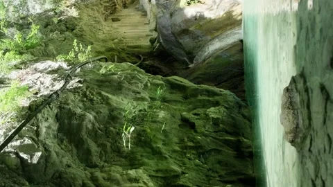 Waterfall ending up in natural pool with emerald water Stock Footage 158332924