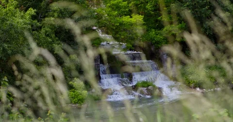 Waterfall entering the river surrounded by Mediterranean nature 4K 50P Video stock 108739886