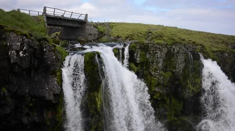 Waterfall falling below bridge, Kirkjufell,  Snæfellsnes peninsula, Iceland Stock Footage 40876073