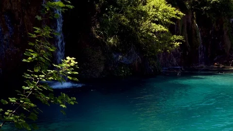 Waterfall falling in the crystal clear blue lake in Plitvice National Park Stock Footage 89159952