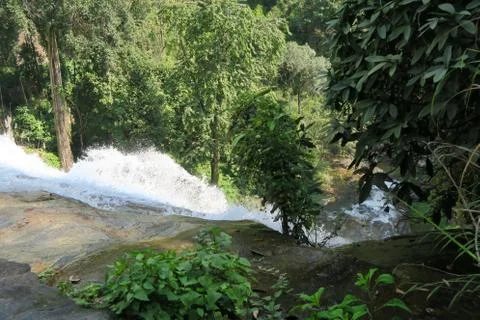 Waterfall falling down the cliff Stock Photos
