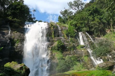 Waterfall falling down the cliffs into the jungle Stock Photos