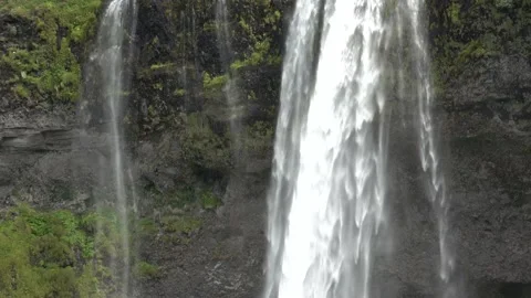 Waterfall falling down from grass grown cliff 4 Stock Footage 136892234