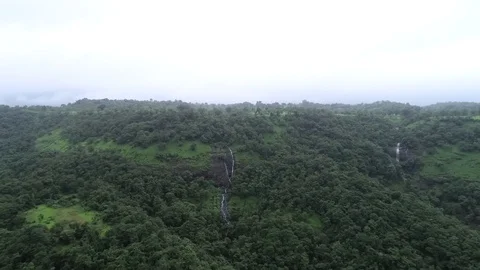 Waterfall falling down the green mountains Stock Footage 106351481