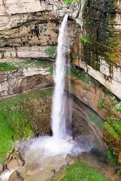 A waterfall falling from a high cliff. Stock Photos