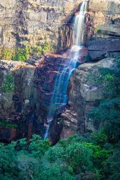 Waterfall falling from mountain top at forests at day from flat angle Stock Photos