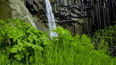 Waterfall falling over the eroded basalt columns Stock Footage 73011471