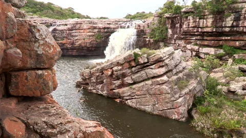 Waterfall falling into a pool in the Mkambati Nature reserve Stock Footage 161803429
