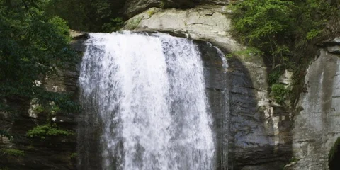Waterfall falling from the rocky mountain in slow motion Stock Footage 103818861