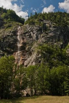 Waterfall falling from slope rocks Stock Photos