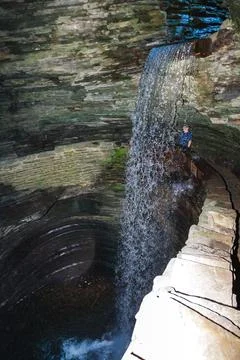 A waterfall falls into a pool among rock formations at Watkins Glen State P.. Stock Photos