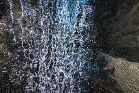 A waterfall falls into a pool among rock formations at Watkins Glen State P.. Stock Photos