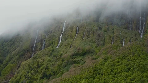 Waterfall of Ferreiro river streams from the cloud on the top of mountain Video stock 118016839