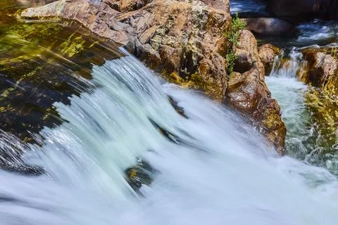 Waterfall Flow Over Smooth Rocks and Summer Light in Mountain River 스톡 사진