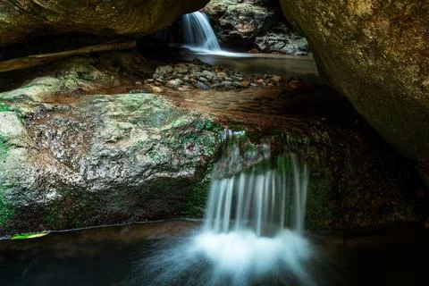 Waterfall flow through cavern Stock Photos