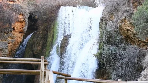 Waterfall flowing behind barrier in slow motion Stock Footage 123110563