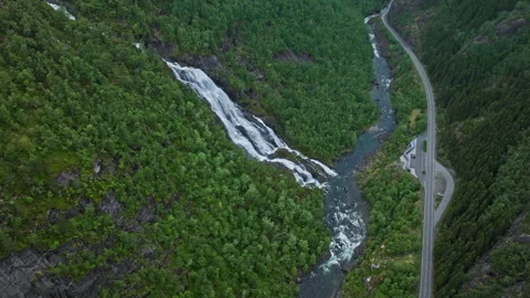 Waterfall flowing beside mountain road at Flesefossen in Brattlandsdalen. Stock Footage 328132530