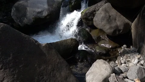 Waterfall flowing between rocks Stock Footage 105434856