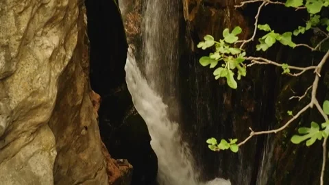 Waterfall flowing between rocks in natural canyon Video stock 310538099