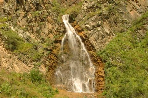 Waterfall flowing down between a caucasus mountains of North Caucasus Stock Photos