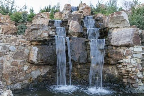 Waterfall flowing down from a cliff close-up. vertical photo 스톡 사진