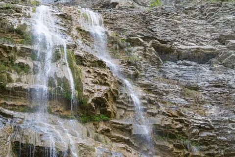Waterfall flowing down from a cliff close-up 스톡 사진