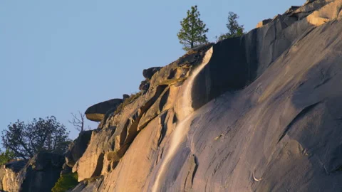 Waterfall flowing down El Capitan rock formation in Yosemite National Park 動画素材 245838672