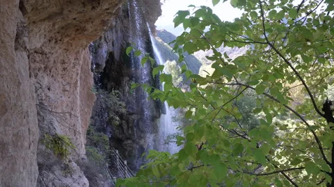 A waterfall flowing down from a high mountain 動画素材 274428703