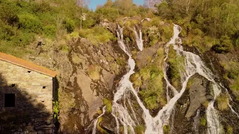 Waterfall Flowing Down The Mountain Cliff On A Sunny Day. - aerial ascend Stock Footage 243595991