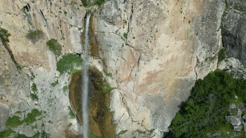 Waterfall flowing high over rocks. Taken with a drone 60Fps 4K video Stock Footage 242398865