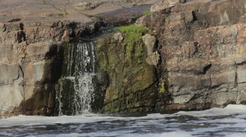 Waterfall flowing into a mountain river Stock Footage 37270910