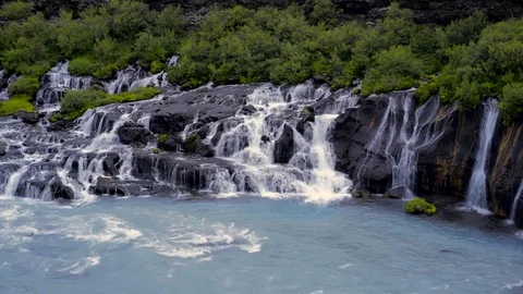 Waterfall flowing over the moss covered rocks Stock Footage 73011018