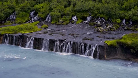 Waterfall flowing over the moss covered rocks Stock Footage 73011393