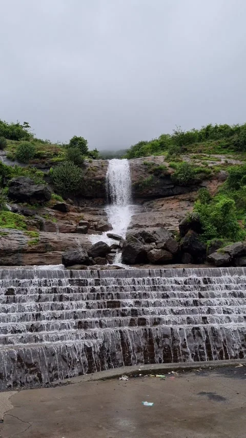 Waterfall flowing over rocks and stepped dam during monsoon Video stock 343860468
