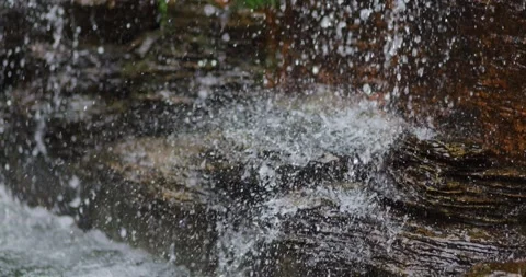 Waterfall flowing over rocks with splashing water and droplets, waterfall n.. Vídeos de archivo 341923940