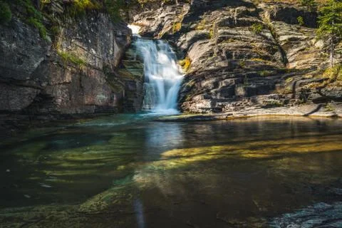 Waterfall flowing into a pond. Stock Photos