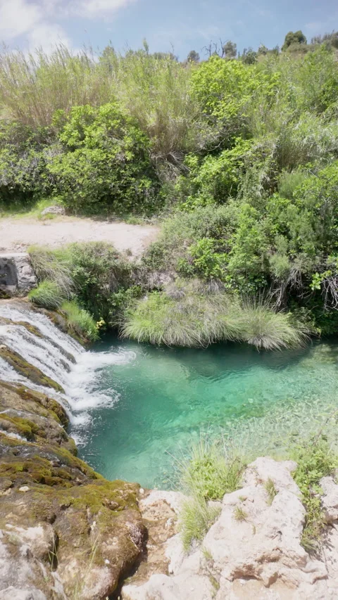 A waterfall is flowing into a pool of water Stock Footage 277410497