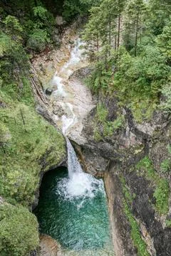 A waterfall is flowing into a pool of water Foto stock