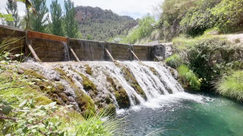 A waterfall is flowing into a river Stock Footage 277408658