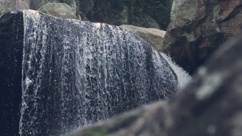 Waterfall flowing on rocks in mountain rainforest. Stream of water mountain Video stock 98163203