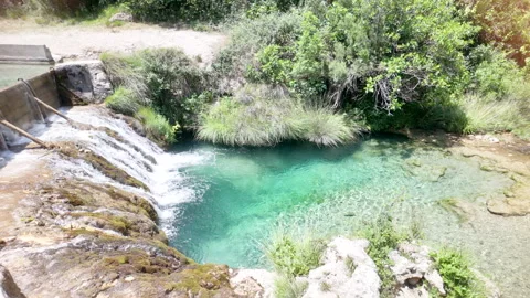 A waterfall is flowing into a small pool of water Stock Footage 277410481