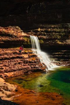 Waterfall flowing streams falling from mountain in green forests at morning f 스톡 사진