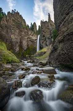 Waterfall flowing through eroded landscape with rock outcrops Tower Fall with 스톡 사진