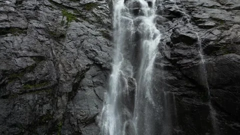 A waterfall flowing through an ice cave  스톡 동영상 332730535