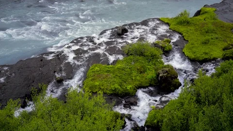 Waterfall flowing through the moss covered rocks Stock Footage 73011050